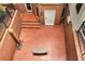 Brick basement entrance featuring steps and a patio area with a metal bench at 1320 Northcliff Trce, Roswell, GA 30076