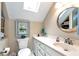 Bathroom featuring a skylight, white vanity and ample cabinet space and shelving at 1320 Northcliff Trce, Roswell, GA 30076