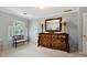 Bedroom featuring neutral walls, bench seating, and a large dresser with decorative mirror at 1320 Northcliff Trce, Roswell, GA 30076