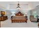 Spacious Primary bedroom with tray ceilings, chair, and abundant natural light at 1320 Northcliff Trce, Roswell, GA 30076