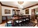 Elegant dining room featuring a chandelier, a china cabinet, and hardwood floors and trim at 1320 Northcliff Trce, Roswell, GA 30076