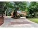 Long driveway leading to a brick home surrounded by mature landscaping and trees at 1320 Northcliff Trce, Roswell, GA 30076