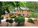 Beautiful two-story brick home featuring a well-manicured lawn and lush, mature landscaping for added privacy at 1320 Northcliff Trce, Roswell, GA 30076