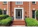 Elegant front entrance with decorative glass door, sidelights, brick steps, and manicured bushes at 1320 Northcliff Trce, Roswell, GA 30076