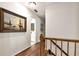 Hallway with hardwood floors leading to a bathroom and bedroom with nautical painting at 1320 Northcliff Trce, Roswell, GA 30076