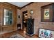 Hallway featuring a brick wall, hardwood floors, a paneled wall, and an arched doorway at 1320 Northcliff Trce, Roswell, GA 30076