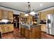 Traditional kitchen features an island with a stainless steel cooktop and appliances at 1320 Northcliff Trce, Roswell, GA 30076
