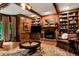 Traditional den featuring hardwood floors, a fireplace with bookshelves, and wood paneling at 1320 Northcliff Trce, Roswell, GA 30076