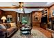 Traditional den with hardwood floors, fireplace, built-in bookshelves and wooden paneling at 1320 Northcliff Trce, Roswell, GA 30076