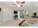 Bedroom featuring neutral carpet and white trim with ensuite bathroom and walk-in closet at 1320 Northcliff Trce, Roswell, GA 30076