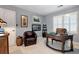 Bright office space with a large window, round desk, and a comfortable leather chair at 1320 Northcliff Trce, Roswell, GA 30076