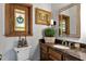Powder room with granite counters, a decorative mirror, and stained glass at 1320 Northcliff Trce, Roswell, GA 30076