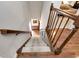 Carpeted staircase with wooden banister and hardwood flooring on the landing at 1320 Northcliff Trce, Roswell, GA 30076