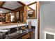 Wet bar featuring a granite countertop, wood cabinets, and an integrated sink at 1320 Northcliff Trce, Roswell, GA 30076