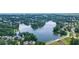 Stunning aerial view of a serene lake surrounded by lush greenery and beautiful homes in the neighborhood at 1775 Porterton Way, Cumming, GA 30041