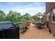 Spacious deck with outdoor dining area, grill, and lush green surroundings, ideal for relaxation and entertaining at 1775 Porterton Way, Cumming, GA 30041