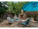 Outdoor patio with a stone fireplace, comfortable seating, and a serene ambiance, perfect for relaxing outdoors at 1775 Porterton Way, Cumming, GA 30041