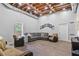 Finished basement with exposed duct work, gray sectional, wood look tile and daylight window at 1775 Porterton Way, Cumming, GA 30041