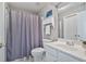 Bathroom featuring a single sink, toilet, shower with gray curtain and vanity at 1775 Porterton Way, Cumming, GA 30041