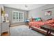 Bright bedroom with hardwood floors, white shutters and ceiling fan at 1775 Porterton Way, Cumming, GA 30041
