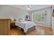 Cozy bedroom with hardwood floors, ceiling fan and window with shutters at 1775 Porterton Way, Cumming, GA 30041