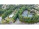 An aerial view of the community featuring a pool, clubhouse, playground, tennis and basketball courts, and lush lake at 1775 Porterton Way, Cumming, GA 30041