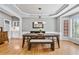 Dining room features elegant wainscoting, hardwood floors, and a bay window at 1775 Porterton Way, Cumming, GA 30041
