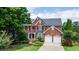 Elegant brick home with a manicured lawn and a two-car garage at 1775 Porterton Way, Cumming, GA 30041