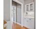 Hallway featuring custom-built cabinets, decorative lighting, and open access to other parts of the home at 1775 Porterton Way, Cumming, GA 30041