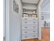 Hallway with a custom-built dresser, offering a practical solution for clothing storage at 1775 Porterton Way, Cumming, GA 30041