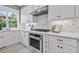 Updated kitchen featuring white cabinets, subway tile backsplash, stainless appliances and lots of natural light at 1775 Porterton Way, Cumming, GA 30041