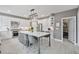 Modern kitchen featuring a large center island, white cabinets, stainless appliances, and lots of storage at 1775 Porterton Way, Cumming, GA 30041
