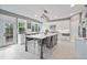 Gorgeous kitchen featuring a large center island, breakfast bar and white cabinetry with stainless appliances at 1775 Porterton Way, Cumming, GA 30041