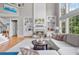 Inviting living room features a fireplace with built-in shelving and two-story windows for ample natural light at 1775 Porterton Way, Cumming, GA 30041