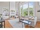 Comfortable living room features built-in shelving flanking the fireplace and large windows offering wooded views at 1775 Porterton Way, Cumming, GA 30041