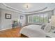 Spacious main bedroom featuring hardwood floors, large windows, and a tray ceiling at 1775 Porterton Way, Cumming, GA 30041