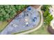 Aerial view of neighborhood playground and park area, surrounded by walking paths and lush greenery at 1775 Porterton Way, Cumming, GA 30041