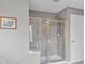 Bathroom shower features sliding glass doors and tiled walls at 1775 Porterton Way, Cumming, GA 30041