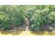 Private waterfront property featuring lake access via wooden stairs and lush natural landscaping at 1775 Porterton Way, Cumming, GA 30041