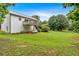 A spacious backyard featuring a wooden deck, green lawn, and a home with white siding at 33 Moriah Ne Way, Rydal, GA 30171