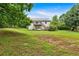 A sprawling backyard with a deck, a white house, and mature trees in the background at 33 Moriah Ne Way, Rydal, GA 30171