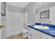 This bathroom has a blue countertop, tan tile floors, a bathtub, toilet and mirror at 33 Moriah Ne Way, Rydal, GA 30171