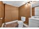 This half bathroom has brown walls, tile floors, a toilet and vanity at 33 Moriah Ne Way, Rydal, GA 30171