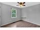 This bedroom features wood floors, a ceiling fan, a window and light gray walls at 33 Moriah Ne Way, Rydal, GA 30171