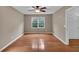 A spacious bedroom featuring hardwood floors, a ceiling fan, and bright natural light at 33 Moriah Ne Way, Rydal, GA 30171