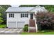 Charming two-story home with white siding, black shutters, and a welcoming staircase at 33 Moriah Ne Way, Rydal, GA 30171
