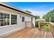This house has a wooden deck, white siding, and a dark metal roof at 33 Moriah Ne Way, Rydal, GA 30171