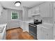 Functional kitchen with white cabinets, stainless steel appliances, and adjacent laundry area at 33 Moriah Ne Way, Rydal, GA 30171
