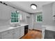 Cozy kitchen with white cabinets and views of the outdoors from multiple windows at 33 Moriah Ne Way, Rydal, GA 30171