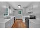 Well-lit kitchen featuring white cabinets, hardwood floors, and modern appliances at 33 Moriah Ne Way, Rydal, GA 30171